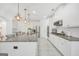 Bright, open kitchen featuring white cabinets, granite countertops, stainless steel appliances and a central island at 3709 Royer Ln # 23, Hampton, GA 30228