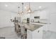 Modern kitchen with stainless steel appliances, granite counters, an island with seating and white cabinets providing ample storage at 3709 Royer Ln # 23, Hampton, GA 30228