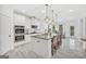 Open-concept kitchen with a center island, granite countertops, stainless steel appliances, and pendant lighting at 3709 Royer Ln # 23, Hampton, GA 30228