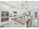 Spacious kitchen featuring a large island with seating, granite countertops, and modern stainless steel appliances at 3709 Royer Ln # 23, Hampton, GA 30228