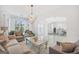 Light-filled living room with modern lighting, neutral tones, and archway leading to dining area at 3709 Royer Ln # 23, Hampton, GA 30228