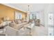 Modern living room with neutral tones, featuring a comfortable sofa and large windows with natural light at 3709 Royer Ln # 23, Hampton, GA 30228