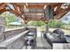 Well-equipped outdoor kitchen with stainless steel grill, cooktop, and ample counter space under a wooden pergola at 3709 Royer Ln # 23, Hampton, GA 30228