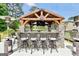 Luxurious outdoor kitchen and bar area with stone accents and a covered structure, perfect for entertaining at 3709 Royer Ln # 23, Hampton, GA 30228