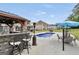 Backyard features a swimming pool, outdoor kitchen, and ample seating for entertaining Gathering and friends at 3709 Royer Ln # 23, Hampton, GA 30228