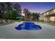 Backyard pool with sun loungers and covered outdoor kitchen against a backdrop of mature trees at dusk at 3709 Royer Ln # 23, Hampton, GA 30228