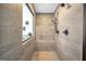 Walk-in shower featuring stylish tile, rainfall shower head, seating and decor at 3709 Royer Ln # 23, Hampton, GA 30228