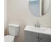 Half bath features a modern vanity with gray cabinets and a round mirror at 4376 Grant Forest Cir, Ellenwood, GA 30294