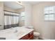 Well-lit bathroom with a vanity, a mirror, and a shower with a curtain at 4376 Grant Forest Cir, Ellenwood, GA 30294