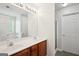 Bright bathroom with double sinks, modern lighting, and a tub with shower at 4376 Grant Forest Cir, Ellenwood, GA 30294
