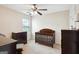 Comfortable Bedroom with dark wood furniture, ceiling fan and plenty of natural light at 4376 Grant Forest Cir, Ellenwood, GA 30294