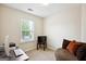 Cozy bedroom with natural light, comfortable seating, and a large window at 4376 Grant Forest Cir, Ellenwood, GA 30294