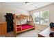 Bright bedroom with a wooden bunk bed, a window view, and modern furnishings at 4376 Grant Forest Cir, Ellenwood, GA 30294