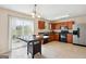 Eat-in kitchen with wooden cabinets, stainless steel appliances, and sliding glass door to backyard at 4376 Grant Forest Cir, Ellenwood, GA 30294