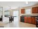 Open eat-in kitchen with wood cabinets, stainless steel appliances, and access to the living room at 4376 Grant Forest Cir, Ellenwood, GA 30294