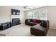 Cozy living room with fireplace, plush sofa, and large windows for ample natural light at 4376 Grant Forest Cir, Ellenwood, GA 30294