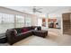 Spacious living room with plush sectional sofa, large windows, and open access to the modern kitchen at 4376 Grant Forest Cir, Ellenwood, GA 30294