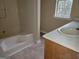 Bathroom featuring a tub with shower, white vanity, and good natural light from the window at 1119 Oakwood Manor Ct, Decatur, GA 30032