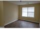 Bedroom featuring new wood flooring, neutral paint, and a large window for plenty of light at 1119 Oakwood Manor Ct, Decatur, GA 30032