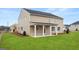 Expansive backyard featuring a covered patio with white columns and ceiling fans at 1808 Quaker St, Hampton, GA 30228