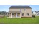Home exterior with a covered porch and a spacious backyard filled with green grass at 1808 Quaker St, Hampton, GA 30228