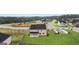 Aerial view of a home's backyard, featuring a lush lawn and a covered patio at 1808 Quaker St, Hampton, GA 30228