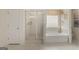 Elegant bathroom with soaking tub, glass-enclosed shower, and decorative window treatment at 1808 Quaker St, Hampton, GA 30228