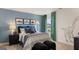 Stylish bedroom with blue accent wall, modern decor, and a view of the neighborhood at 1808 Quaker St, Hampton, GA 30228
