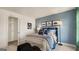 Blue-themed bedroom featuring a modern bed, stylish decor, and closet space at 1808 Quaker St, Hampton, GA 30228