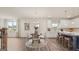 Open-concept dining area and kitchen with hardwood floors and natural light at 1808 Quaker St, Hampton, GA 30228