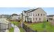 Two-story home showcasing a manicured lawn, stone accents, and a gated entrance at 1808 Quaker St, Hampton, GA 30228