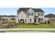 Attractive two-story home with brick accents, a manicured lawn, and a covered front porch at 1808 Quaker St, Hampton, GA 30228