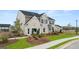 Beautiful two-story home with brick accents, a manicured lawn, and a paved walkway at 1808 Quaker St, Hampton, GA 30228