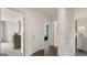 Hallway leading to rooms with modern finishes, showcasing a glimpse of multiple rooms and natural light at 1808 Quaker St, Hampton, GA 30228