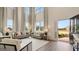 Bright living room with soaring ceilings, multiple windows, neutral furniture, and an open entryway at 1808 Quaker St, Hampton, GA 30228