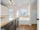 Bathroom featuring double vanity, soaking tub under window, and walk-in shower at 2373 Aukerman Trce # 83, Hampton, GA 30228