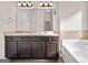 Double vanity with granite counters and tile backsplash beside soaking tub at 2373 Aukerman Trce # 83, Hampton, GA 30228