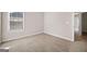 Bright bedroom with window and neutral carpet flooring and open doorway at 2373 Aukerman Trce # 83, Hampton, GA 30228