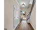 Entry hallway featuring wood floors, a staircase, and view of the front yard at 2373 Aukerman Trce # 83, Hampton, GA 30228