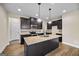 Beautiful kitchen featuring dark cabinets, granite countertops, and an island with a sink at 2373 Aukerman Trce # 83, Hampton, GA 30228
