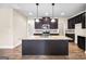 Modern kitchen with granite countertops, dark cabinets, and stainless steel appliances at 2373 Aukerman Trce # 83, Hampton, GA 30228