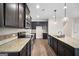 Stylish kitchen with dark cabinetry, granite countertops, stainless steel appliances, and an island at 2373 Aukerman Trce # 83, Hampton, GA 30228