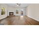 Open living room with fireplace, wood floors, neutral paint, and natural light at 2373 Aukerman Trce # 83, Hampton, GA 30228