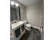 Bathroom featuring stylish vanity with modern fixtures, a toilet and gray tile floors at 59 S Old Hwy 27, Roopville, GA 30170