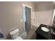 Bright bathroom with a dark countertop vanity and shower/tub combo at 59 S Old Hwy 27, Roopville, GA 30170