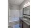 Bathroom featuring a combination tub and shower, dark wood vanity, and modern fixtures at 59 S Old Hwy 27, Roopville, GA 30170