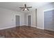 Clean bedroom features hardwood floors, neutral paint, multiple windows, and three grey doors at 59 S Old Hwy 27, Roopville, GA 30170