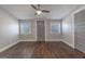 Clean bedroom features hardwood floors, neutral paint, multiple windows and ceiling fan at 59 S Old Hwy 27, Roopville, GA 30170