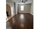 Spacious bedroom with beautiful dark hardwood flooring and a ceiling fan at 59 S Old Hwy 27, Roopville, GA 30170