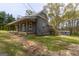 Charming gray home featuring a metal roof, inviting front porch and walkway, and freshly landscaped yard at 59 S Old Hwy 27, Roopville, GA 30170